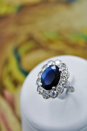 Downstairs at Grays, a remarkable Oval Sapphire & Diamond Cluster Ring mounted in Platinum, French, Circa 1935