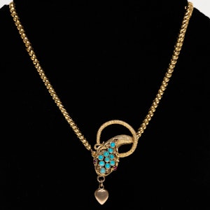 Victorian snake necklace with turquoise head and ruby eyes holding a heart