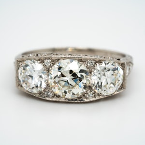 Platinum set Art Deco large 3 stone ring  with diamond studded mount