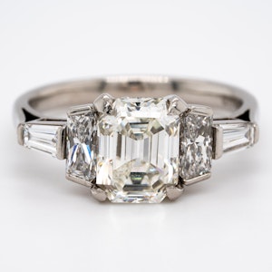 Diamond 3 stone ring with tapered baguettes diamond shoulders