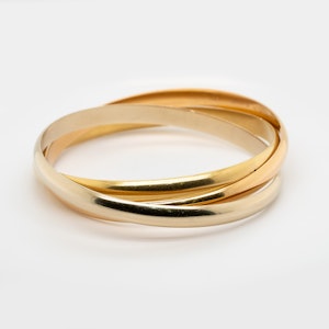 Heavy ,wide trinity bangle signed Cartier