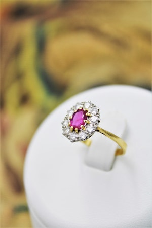 A very fine Oval Natural Ruby & Diamond Cluster Engagement Ring mounted in 18ct Yellow Gold, Circa 1955