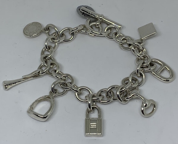 Hermes silver charm bracelet with charms that are from their iconic collections - image 1