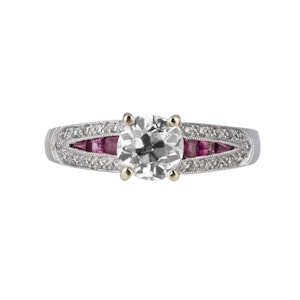 Diamond solitaire ring with diamond shoulders and ruby insets