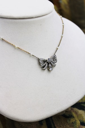 A very fine Victorian Diamond Bow Pendant mounted in Silver and High Carat Yellow Gold, English, Circa 1890