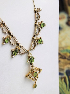 Downstairs at Grays, an Antique Peridot & Seed Pearl Festoon La Belle Époque Necklace with a matching Quatrefoil style detachable Pendant/Brooch in 15 Carat Yellow Gold, English, Circa 1900