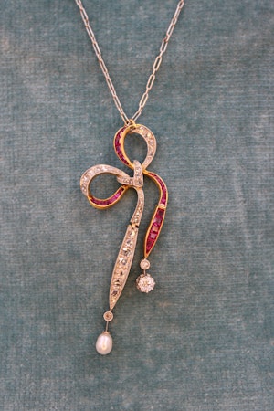 Downstairs at Grays: A Diamond, Ruby & Pearl Bow Pendant set in 18ct Yellow Gold and Platinum, Circa 1915