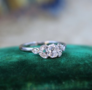 A beautiful 0.45 Carat "F Colour" Diamond Engagement Ring, with Diamond Set Foliate Shoulders, English, Circa 1930
