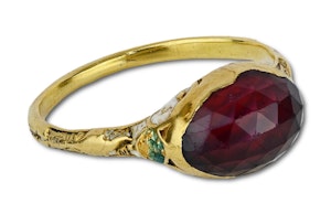 Gold and enamel ring set with a faceted garnet. English, 17th century.