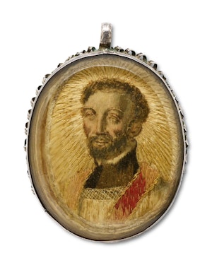 Silver pendant with a needlework picture of Saint Francis. Spanish, 18th century