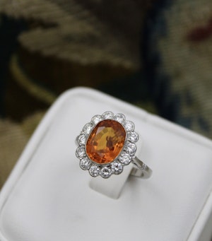 Downstairs at Grays: A very fine 18 carat White Gold, Orange Ceylon Sapphire and Diamond Cluster Ring.
