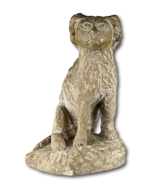 Primitive limestone sculpture of a seated spaniel. English, 17th / 18th century.