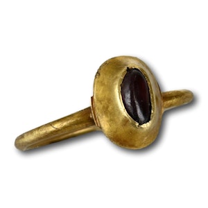 Medieval stirrup ring set with a cabochon garnet. English, 13/14th century.