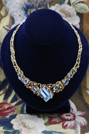 Downstairs at Grays: A Stunning 18 Carat Yellow Gold Aquamarine and Diamond Necklace, attributed to Arthur King, with a Natural, Untreated Aquamarine of 27.11 Carats. Circa 1970.