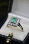A very fine Platinum (tested) Cluster Ring set with a Modified Step Cut Emerald surrounded by gallery of fourteen Single Cut Diamonds. Circa 1930 - image 1