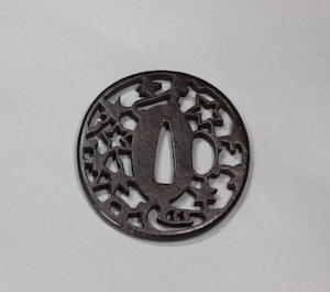 Japanese iron sukashi tsuba (sword guard with openwork detail)