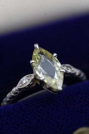 An excellent Platinum (tested) Marquise Shaped Natural and Untreated Fancy Yellow Diamond Solitaire Ring. Circa 1930.
