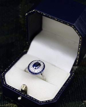 Downstairs at Grays: A fine Platinum, Diamond & Sapphire Oval Target Ring, centrally Rub-over set with an Unheated Burma Sapphire. French. Circa 1930.