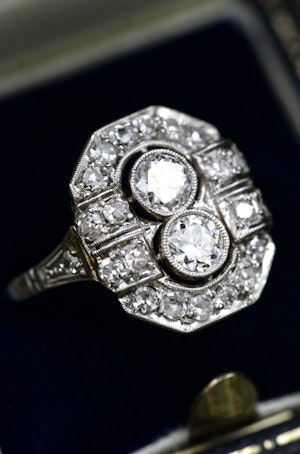 Downstairs at Grays: A very fine Art Deco Double Diamond Plaque Ring in Platinum (Tested). Centrally Rub-over set in the floating style with two 'Old European Cut' Diamonds. Circa 1930.