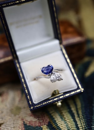 Downstairs at Grays: A remarkable 18ct White Gold (French import marks), Heart Shaped Sapphire & Diamond, Moi et Toi, Two Stone Twist Ring. Pre-owned