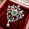 A very fine Edwardian Pendant/Brooch, a central Emerald & Diamond Cluster within a foliate stylised Heart Shaped Diamond Set frame suspending a Pear shaped Natural Pearl. Circa 1890 - image 2