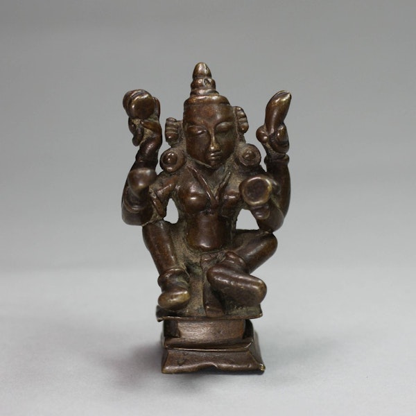 Indian miniature bronze of a seated four-armed figure, mid-19th century - image 1