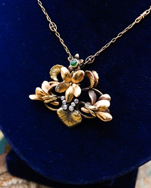 Downstairs in Grays: A very fine High Carat Yellow Gold (18 ct. Tested), Art Nouveau Emerald & Diamond Floral Pendant, worn marks. Circa 1900
