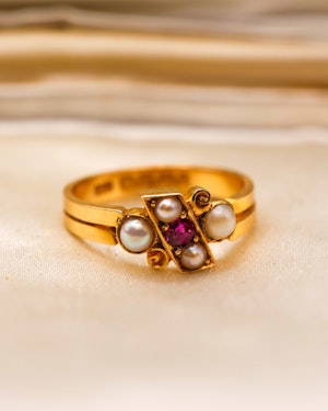 Downstairs at Grays: A stunning 18 Carat Yellow Gold Crossover Ring with Ruby and Pearls
