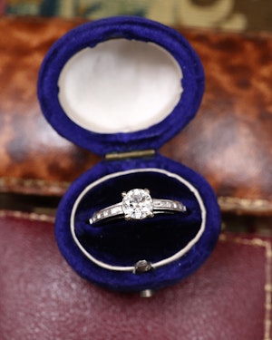 Downstairs at Grays: A very fine 18 ct White Gold Diamond  Solitaire Ring, 0.66 Carats Approximately, with shoulder settings of 0.18 Carats (stamped) of Modified Step Cut Diamonds.  Preowned