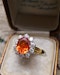 A very fine 18 Carat Yellow & White Gold Oval Fire Opal and Diamond Cluster Ring. London Hallmarks. Circa 1993. - image 1