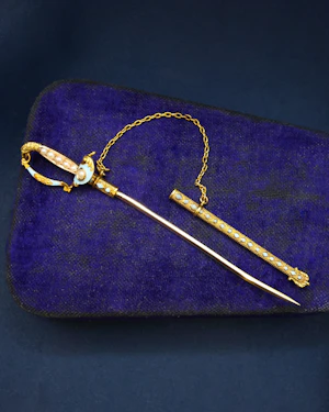 Downstairs at Grays: A very finely worked High Carat Yellow Gold Turquoise, Enamel & Pearl Sword Pin, with Eagles Head. Circa 1890