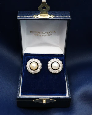 Downstairs at Grays: A fine pair of Natural Pearl and Old European Cut Diamond Cluster Earrings in Platinum & 18ct Gold (tested), Mounts. Circa 1930.