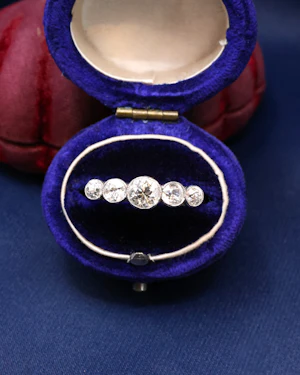Downstairs at Grays: A very fine 18ct. White Gold graduating five stone Diamond Ring, set with five Old European Cut, Natural Diamonds. Circa 1930