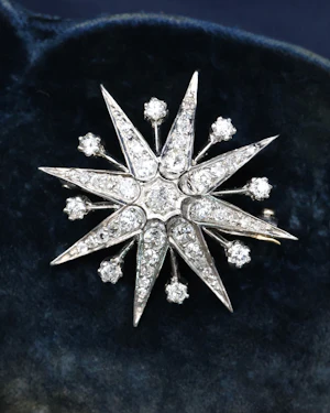 A fine Victorian Diamond Starburst Brooch, in 15ct Gold (silver tipped), with later Rhodium plating. Circa 1890.