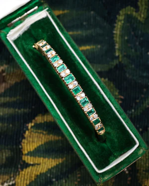 A very fine 15 ct Yellow Gold (tested), 2.20 Carat Colombian Emerald & Diamond Half Hinged Bangle. English Circa 1900.