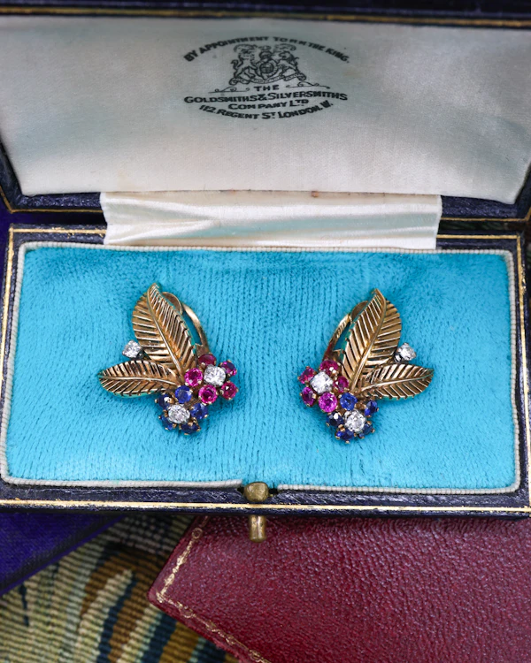 A very fine pair of 18ct Yellow & White Gold (tested), Retro, Clip Earrings,  a Stylised Foliate Design set throughout with Diamonds, Burma Rubies & Sapphires. Circa 1940 - image 2