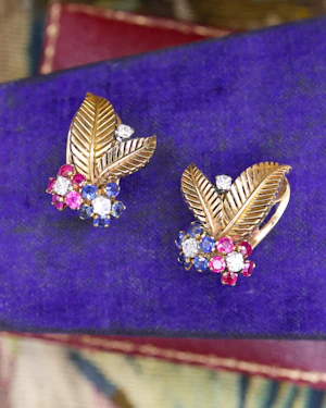A very fine pair of 18ct Yellow & White Gold (tested), Retro, Clip Earrings,  a Stylised Foliate Design set throughout with Diamonds, Burma Rubies & Sapphires. Circa 1940