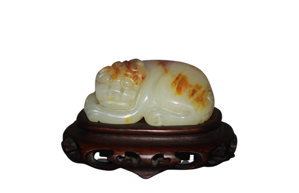 A Chinese jade carving of a lion dog. - image 1