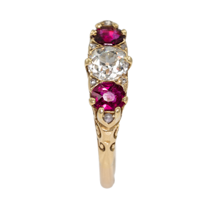 Ruby and diamond three stone half hoop carved ring with diamond points